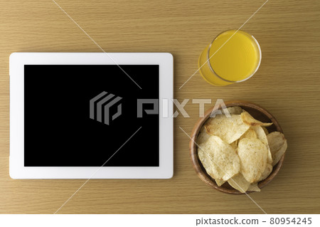 Image of eating a snack during breaks and using a tablet device Image of eating a snack during breaks and using a tablet device 80954245