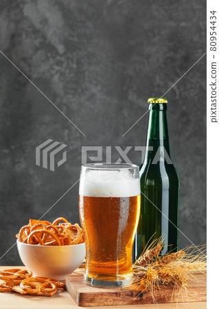 Lager beer and snacks on stone table. Cracker, chips side view Lager beer and snacks on stone table. Cracker, chips side view 80954434