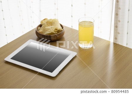 Image of eating a snack during breaks and using a tablet device Image of eating a snack during breaks and using a tablet device 80954485