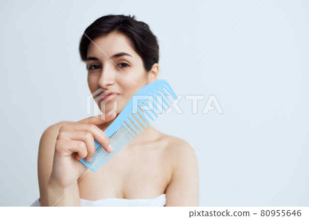 woman with bare shoulders combing hair head care hygiene woman with bare shoulders combing hair head care hygiene 80955646