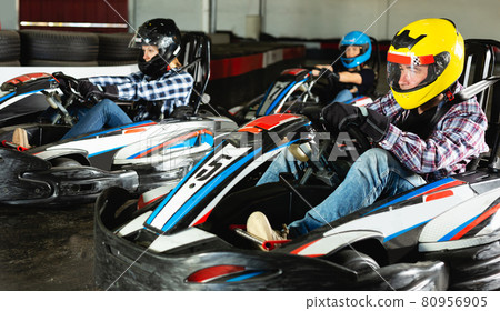 Young people driving sport cars for karting Young people driving sport cars for karting 80956905