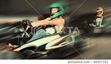 Woman driving sport car for karting in a circuit lap in sport c Woman driving sport car for karting in a circuit lap in sport c 80957191