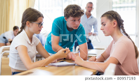 Teenager students performing group tasks Teenager students performing group tasks 80957193