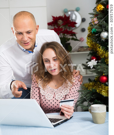 Couple shopping online at home Couple shopping online at home 80957659