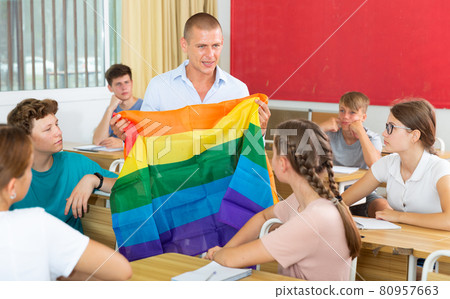 Pupils in classroom listen to teacher who explains what is LGBT Pupils in classroom listen to teacher who explains what is LGBT 80957663