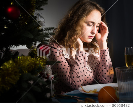 Girl is bored and drinking champagne in New Year nigh 80958482