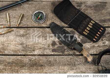 Hunting equipment on old dark wooden background Hunting equipment on old dark wooden background 80958699