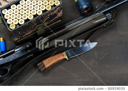 Hunting rifle and cartridges on dark wooden background 80959030