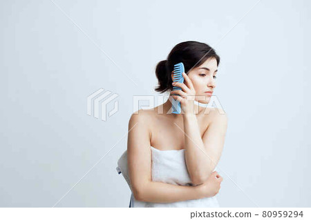 woman with bare shoulders combing hair head care hygiene woman with bare shoulders combing hair head care hygiene 80959294