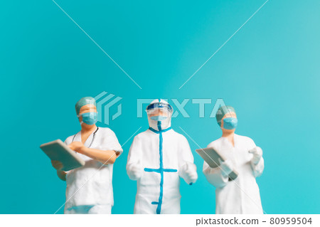 Miniature people A medical officer in a protective uniform Miniature people A medical officer in a protective uniform 80959504