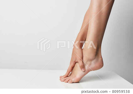 female leg massage joint pain injury close-up 80959538
