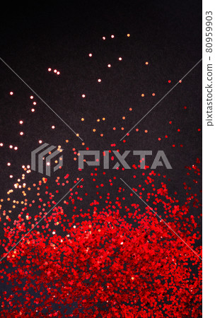 Red glitter on black paper background with copy space, flat lay Red glitter on black paper background with copy space, flat lay 80959903