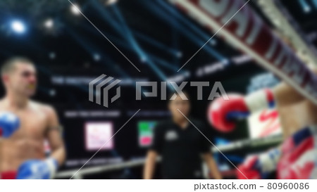 Thai Kick boxing. Blurred images of Muay Thai. Martial Art Kickboxing. Local and foriegn boxer are fighting on the ring at indoor stadium stage. Muaythai is sport competition for traveller sightseeing Thai Kick boxing. Blurred images of Muay Thai. Martial Art Kickboxing. Local and foriegn boxer are fighting on the ring at indoor stadium stage. Muaythai is sport competition for traveller sightseeing 80960086