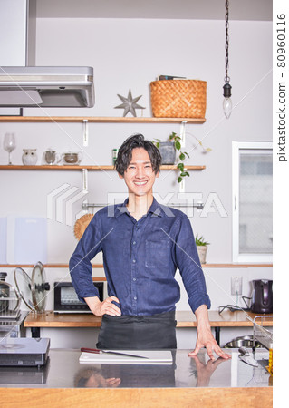 Young man standing in the kitchen with an apron Cooking boy image 80960116