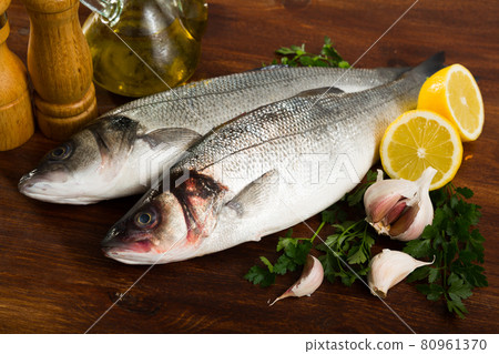 European basses with spices on wooden background 80961370