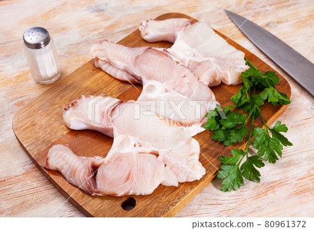 Uncooked tiger shark fillet fish with parsley and lemon on table 80961372