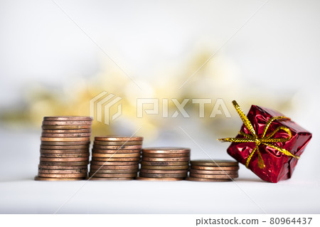 Coin climbing stairs with Christmas Holiday present, sparkling and shiny background, Finance,saving concept stacks of coins 80964437