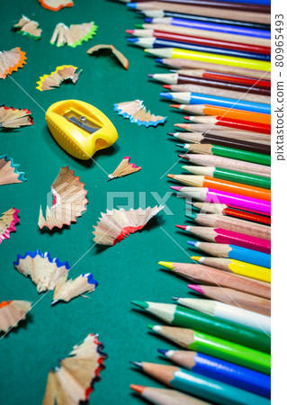 Colorful pencils over green chalkboard 80965493