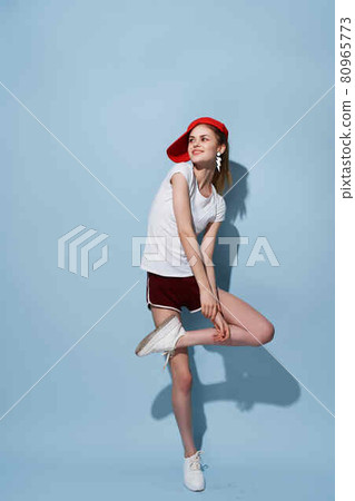 cheerful girl in white t-shirt and shorts posing fashion full length fun cheerful girl in white t-shirt and shorts posing fashion full length fun 80965773