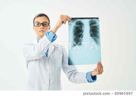 female doctor holding an x-ray in front of her hospital treatment diagnosis 80965997