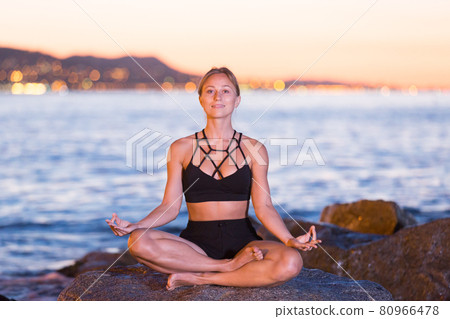 Young woman is meditating 80966478