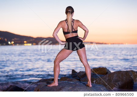 Female 24-31 years old is practicing stretching Female 24-31 years old is practicing stretching 80966500