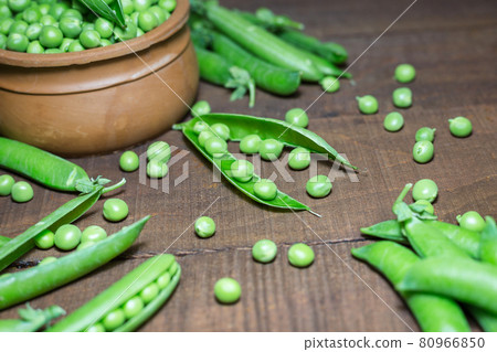 Green peas on wooden background Green peas on wooden background 80966850