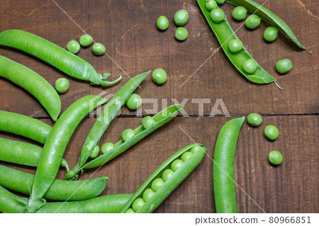 Green peas on wooden background Green peas on wooden background 80966851