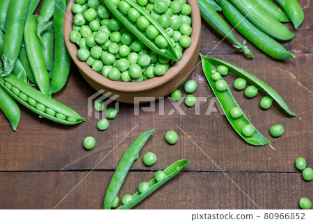 Green peas on wooden background 80966852