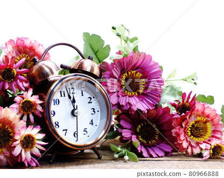 spring time with alarm clock and artificial flowers bouquet background spring time with alarm clock and artificial flowers bouquet background 80966888