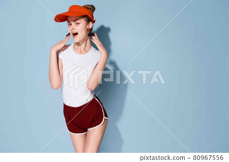 cheerful woman ape face red cap fashion summer blue background 80967556
