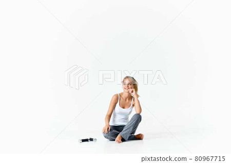 woman sitting barefoot on the floor dumbbells in hands exercise muscles workout 80967715