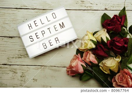 Hello September Word on Light box with roses flower bouquet on wooden background Hello September Word on Light box with roses flower bouquet on wooden background 80967764