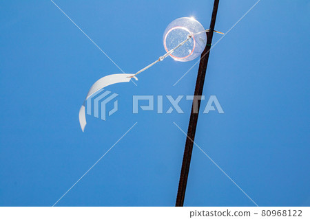 A wind chime swaying in the midsummer blue sky and wind 80968122