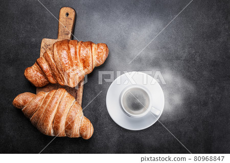 croissants lie on the black breakfast table 80968847