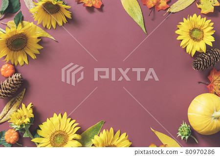 Creative frame made of festive autumn decor of pumpkins, sunflowers and leaves on a brown background. Autumn composition. Nature Trendy Decorative Design. Flat lay, copy space. Creative frame made of festive autumn decor of pumpkins, sunflowers and leaves on a brown background. Autumn composition. Nature Trendy Decorative Design. Flat lay, copy space. 80970286
