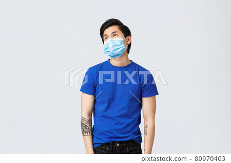 Different emotions, social distancing, self-quarantine on covid-19 and lifestyle concept. Bored and bothered asian guy unwilling working from home today, sighing and look up reluctant and indifferent 80970403