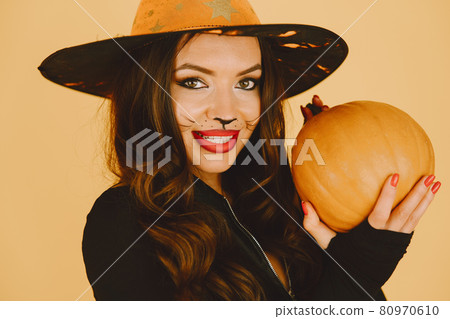 Young woman in haloween costume pose on color background Young woman in haloween costume pose on color background 80970610