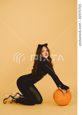 Woman with cat makeup and ears on color background Woman with cat makeup and ears on color background 80970705