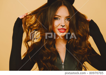 Woman with cat makeup and ears on color background Woman with cat makeup and ears on color background 80970785