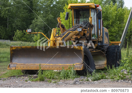 Old yellow tractor grader. Bashkortostan, Russia - 12 June, 2021. Old yellow tractor grader. Bashkortostan, Russia - 12 June, 2021. 80970873