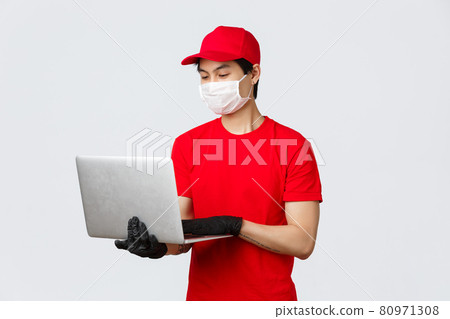 Handsome asian delivery guy in medical mask and gloves, red cap uniform, answer clients questiones on webpage, customer support at courier service using laptop, searching your parcel Handsome asian delivery guy in medical mask and gloves, red cap uniform, answer clients questiones on webpage, customer support at courier service using laptop, searching your parcel 80971308