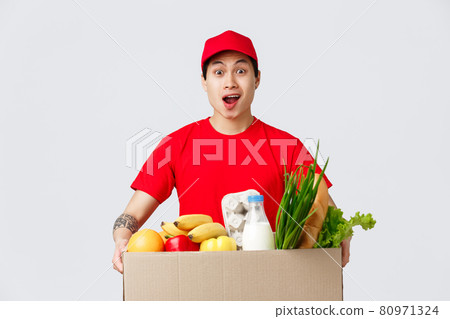 Online shopping, food delivery and internet stores concept. Shocked asian delivery guy carry huge box of client order, hold groceries product package, courier astonished 80971324