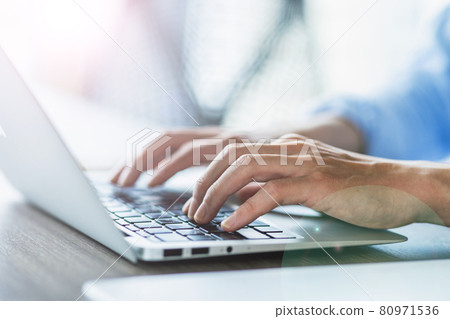 Image of a young man typing on a laptop computer shooting cooperation "+ SHIFT NOGIZAKA" 80971536