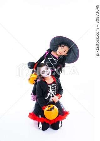 Portrait pair of little girls in Halloween and carnival costume isolated on white background 80973049