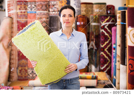 Female touching and choosing carpets Female touching and choosing carpets 80973421
