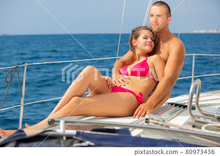 Couple enjoying sea trip on sailboat 80973436