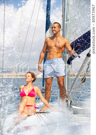 Couple enjoying sea trip along coast of Barcelona 80973967