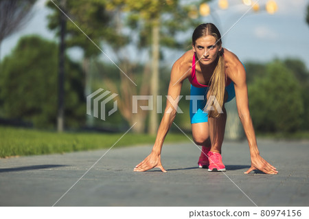 Young slim sportive caucasian woman working out, doing fitness in the park or on city street. Young slim sportive caucasian woman working out, doing fitness in the park or on city street. 80974156