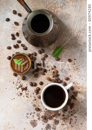 Background with Coffee cup and beans on concrete table. Top view flat lay background. Background with Coffee cup and beans on concrete table. Top view flat lay background. 80974280